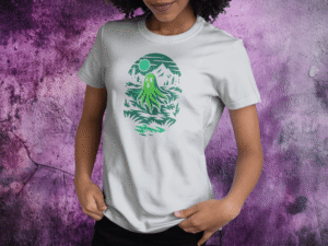 White t-shirt featuring a glowing green ghost drifting through a hollow under a full moon.